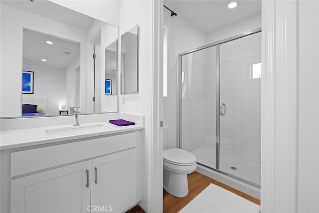 181 Moonflower Rd, Rancho Mission Viejo, CA 92694 - bathroom featuring a shower stall, toilet, vanity, wood finished floors, and recessed lighting