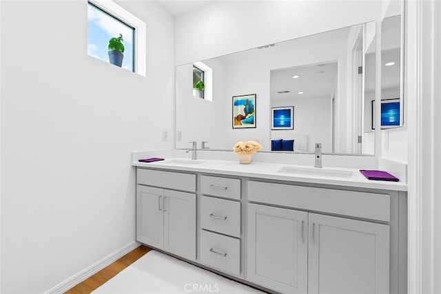 181 Moonflower Rd, Rancho Mission Viejo, CA 92694 - bathroom featuring double vanity, wood finished floors, and baseboards