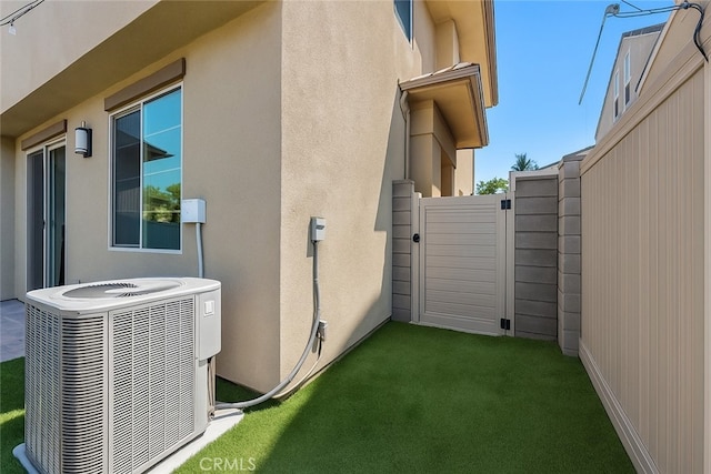 181 Moonflower Rd, Rancho Mission Viejo, CA 92694 - view of property exterior with cooling unit, stucco siding, and a gate