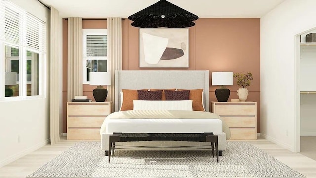 24943 Sirius St, Moreno Valley, CA 92551 - bedroom featuring light wood-style flooring, a spacious closet, and baseboards