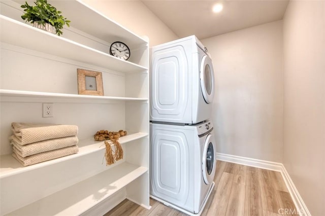 1151 Brush Crk, Rancho Mission Viejo, CA 92694 - laundry room featuring estacked washer and dryer, baseboards, and light wood finished floors