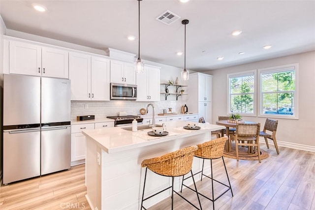 1151 Brush Crk, Rancho Mission Viejo, CA 92694 - kitchen featuring stainless steel appliances, light countertops, decorative backsplash, white cabinets, and recessed lighting