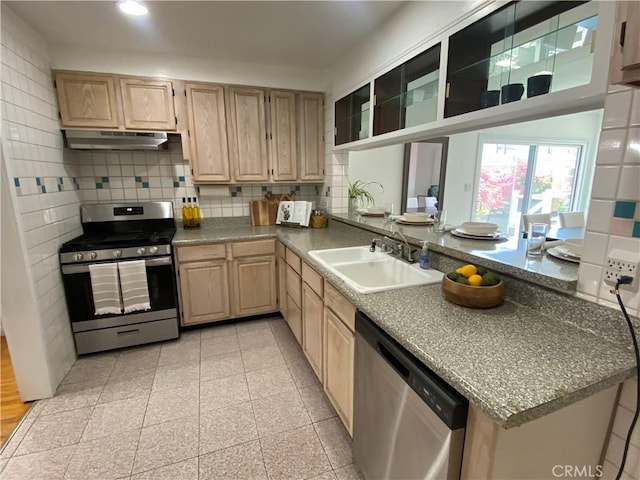 619 Center St, El Segundo, CA 90245 - kitchen featuring stainless steel appliances, light brown cabinets, a sink, under cabinet range hood, and backsplash