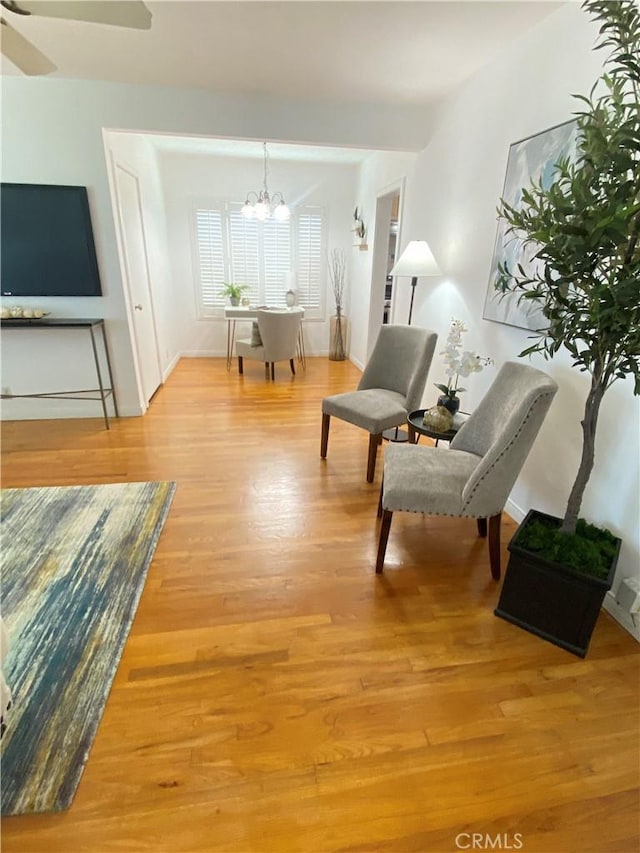 619 Center St, El Segundo, CA 90245 - living area featuring a chandelier, light wood-type flooring, and baseboards