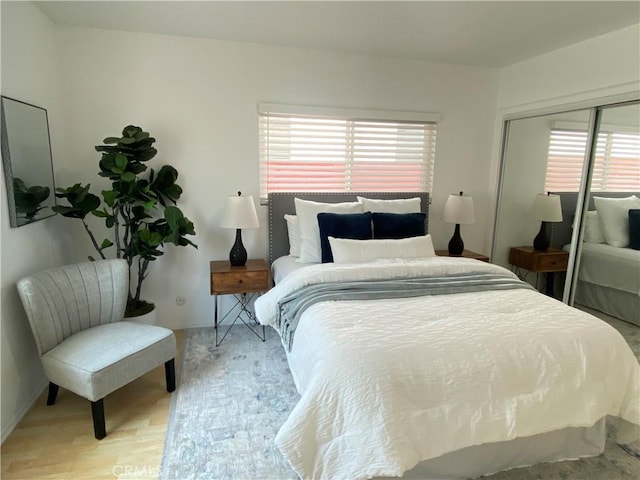 619 Center St, El Segundo, CA 90245 - bedroom featuring a closet, light wood-type flooring, and baseboards