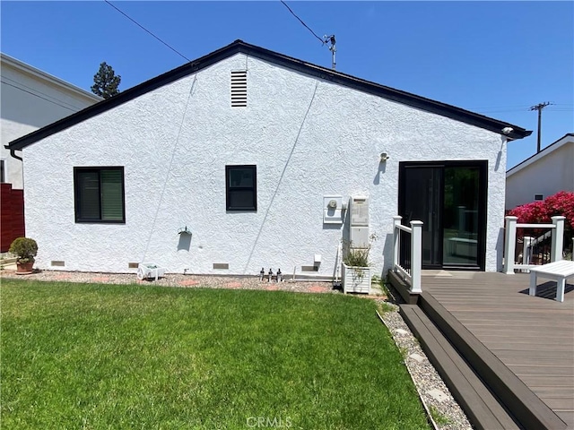 619 Center St, El Segundo, CA 90245 - rear view of house featuring a deck, crawl space, a yard, and stucco siding
