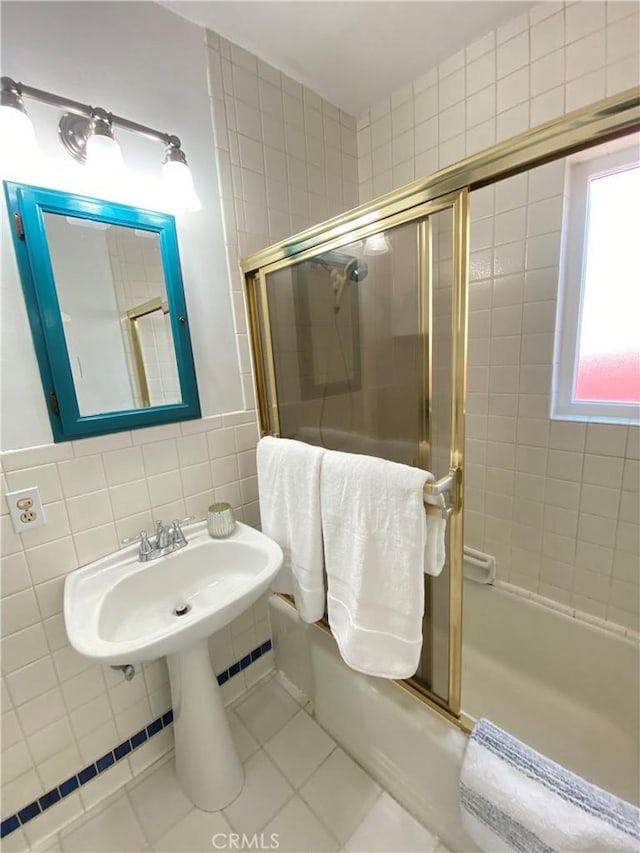 619 Center St, El Segundo, CA 90245 - bathroom with tile walls, bath / shower combo with glass door, and tile patterned flooring