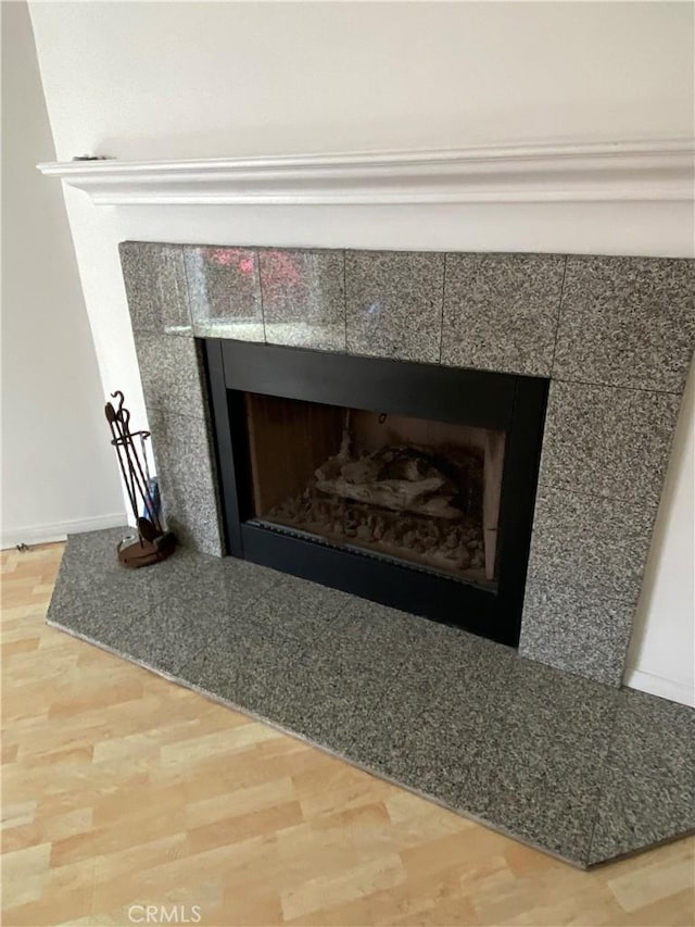 619 Center St, El Segundo, CA 90245 - detailed view of a tiled fireplace, wood finished floors, and baseboards