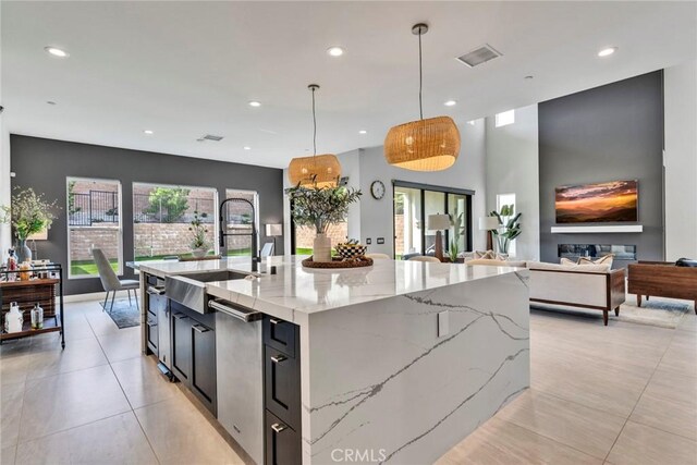 20537 W Overlook Ct, Porter Ranch, CA 91326 - kitchen featuring a sink, recessed lighting, a large island with sink, light stone countertops, and open floor plan