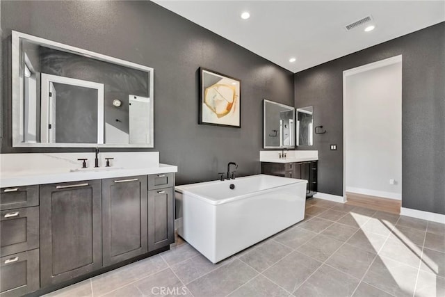 20537 W Overlook Ct, Porter Ranch, CA 91326 - bathroom with a soaking tub, tile patterned floors, two vanities, baseboards, and recessed lighting