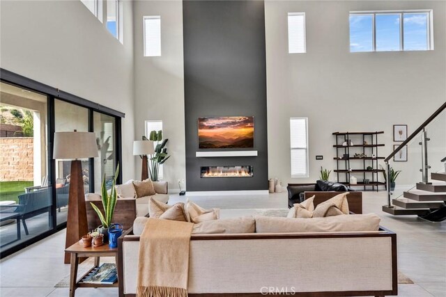 20537 W Overlook Ct, Porter Ranch, CA 91326 - living area featuring a high ceiling, a glass covered fireplace, and stairs