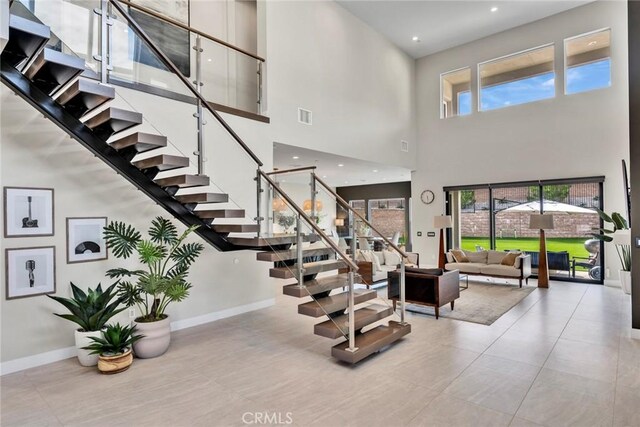 20537 W Overlook Ct, Porter Ranch, CA 91326 - stairway with a high ceiling, baseboards, and tile patterned flooring