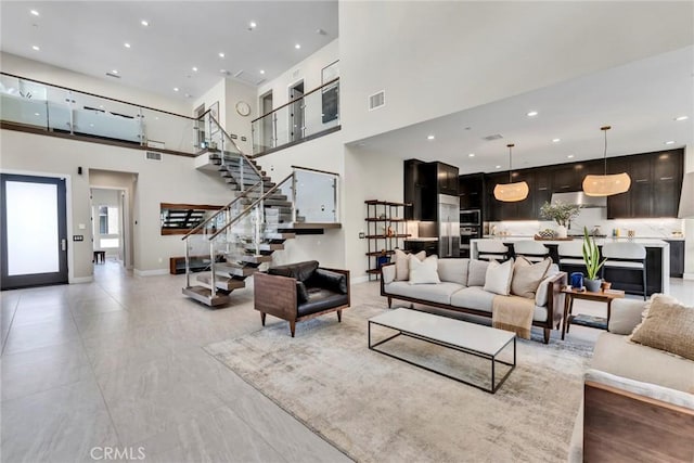 20537 W Overlook Ct, Porter Ranch, CA 91326 - living room featuring a towering ceiling, stairway, baseboards, and recessed lighting