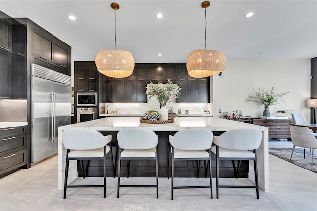 20537 W Overlook Ct, Porter Ranch, CA 91326 - kitchen featuring built in appliances, backsplash, recessed lighting, hanging light fixtures, and a large island