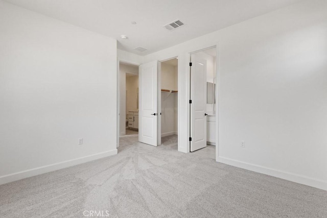 17744 Mcdowell Valley Dr, Riverside, CA 92503 - unfurnished bedroom with light colored carpet, baseboards, a walk in closet, and a closet