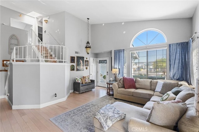 1337 Lloyd Pl, Lompoc, CA 93436 - living room with stairway, wood finished floors, a towering ceiling, and baseboards