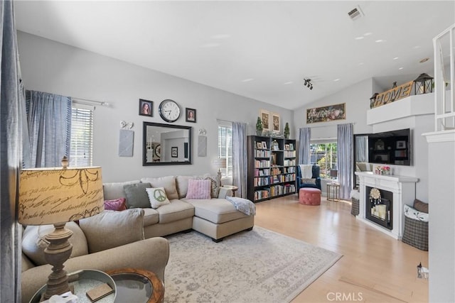 1337 Lloyd Pl, Lompoc, CA 93436 - living area featuring a fireplace, wood finished floors, and vaulted ceiling