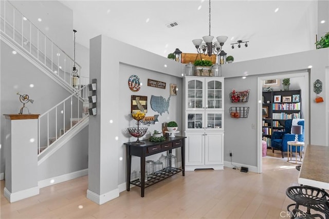 1337 Lloyd Pl, Lompoc, CA 93436 - foyer featuring stairway, light wood finished floors, a chandelier, baseboards, and a high ceiling
