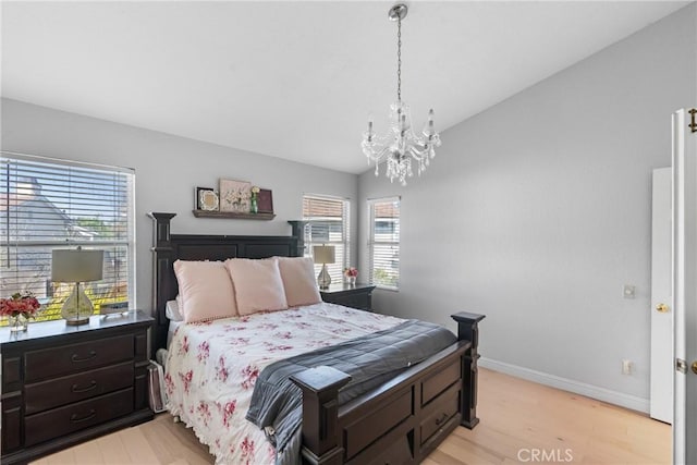 1337 Lloyd Pl, Lompoc, CA 93436 - bedroom featuring multiple windows, a chandelier, light wood-style floors, baseboards, and lofted ceiling