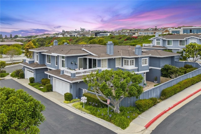 3510 Lilac Ave Unit 13, Corona Del Mar, CA 92625 - view of front of property featuring a chimney, a garage, a residential view, a balcony, and concrete driveway
