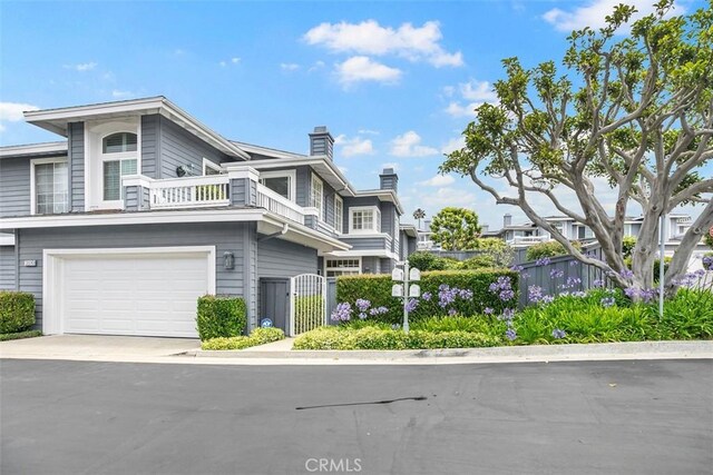 3510 Lilac Ave Unit 13, Corona Del Mar, CA 92625 - view of front facade with a chimney, a gate, a garage, a balcony, and driveway