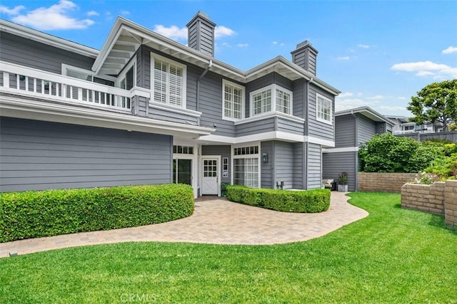 3510 Lilac Ave Unit 13, Corona Del Mar, CA 92625 - rear view of property with a balcony, a chimney, and a yard