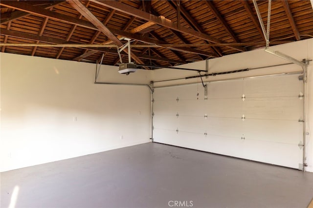 3554 S Sycamore Ave, Los Angeles, CA 90016 - garage featuring a garage door opener and baseboards