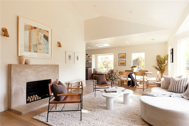 3554 S Sycamore Ave, Los Angeles, CA 90016 - living area featuring wood finished floors, a premium fireplace, and high vaulted ceiling