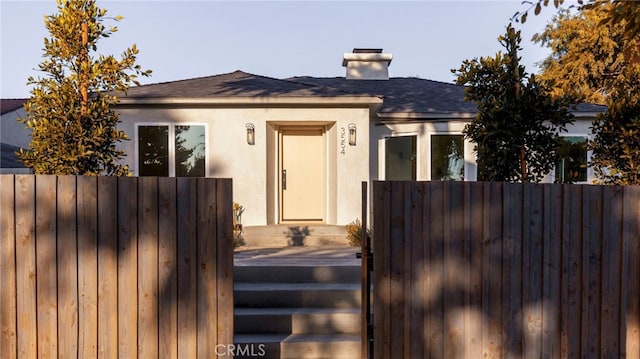 3554 S Sycamore Ave, Los Angeles, CA 90016 - view of front of property featuring stucco siding, roof with shingles, and a chimney