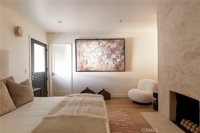 3554 S Sycamore Ave, Los Angeles, CA 90016 - bedroom with wood finished floors, a fireplace, and baseboards
