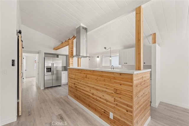 12340 Dune St, Norwalk, CA 90650 - kitchen featuring stainless steel fridge with ice dispenser, wall chimney exhaust hood, light wood-type flooring, lofted ceiling, and a peninsula