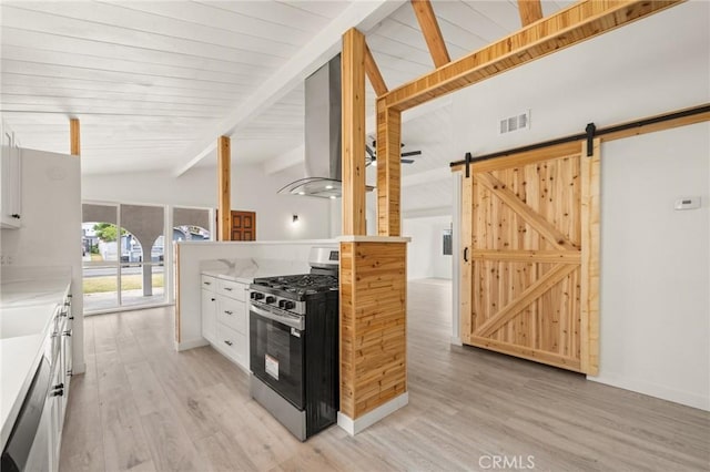 12340 Dune St, Norwalk, CA 90650 - kitchen featuring gas stove, a barn door, light wood finished floors, white cabinets, and light countertops