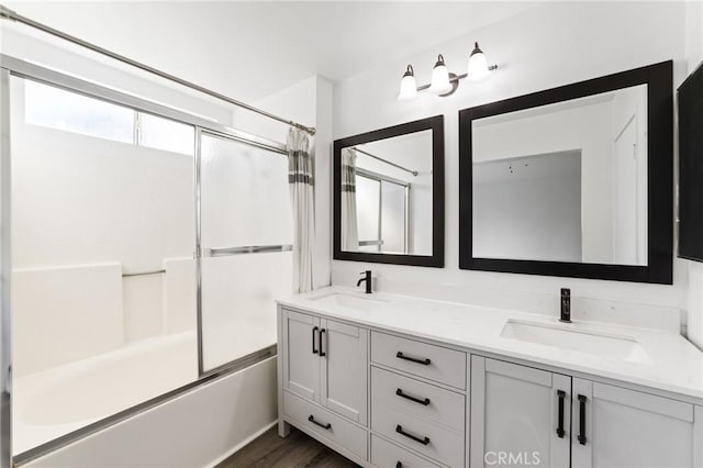 16207 Trailwinds Dr, Fontana, CA 92337 - full bathroom with double vanity, shower / bath combination with glass door, and wood finished floors