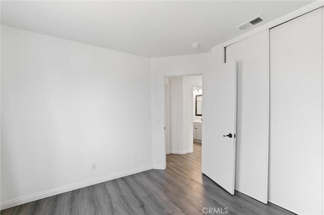 16207 Trailwinds Dr, Fontana, CA 92337 - unfurnished bedroom with wood finished floors and a closet