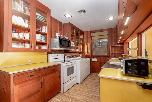 4899 Glenwood Dr, Riverside, CA 92501 - kitchen featuring white electric range oven, stainless steel microwave, washer and dryer, light wood-style floors, and light countertops