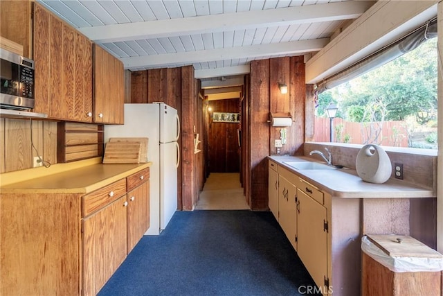 4899 Glenwood Dr, Riverside, CA 92501 - kitchen with a sink, stainless steel microwave, light countertops, freestanding refrigerator, and carpet flooring