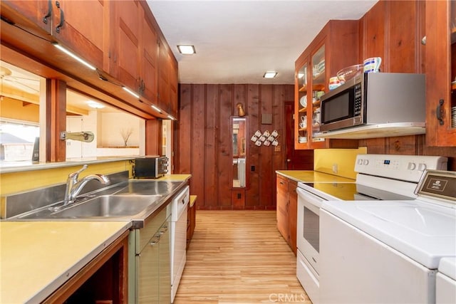 4899 Glenwood Dr, Riverside, CA 92501 - kitchen with stainless steel microwave, light wood-style floors, light countertops, wooden walls, and separate washer and dryer