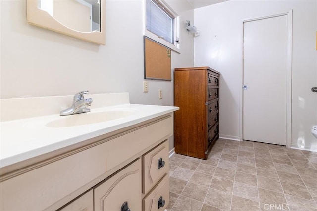 4899 Glenwood Dr, Riverside, CA 92501 - bathroom featuring vanity, toilet, and stone finish floors