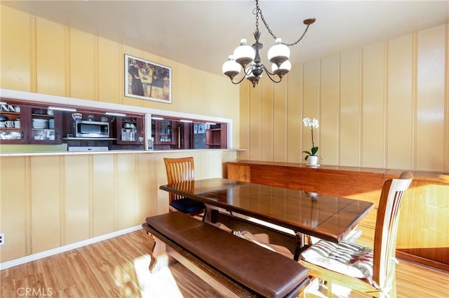 4899 Glenwood Dr, Riverside, CA 92501 - dining area featuring a decorative wall, a chandelier, and light wood-style floors