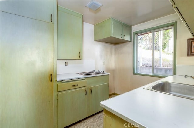 4899 Glenwood Dr, Riverside, CA 92501 - kitchen with light countertops, a sink, and electric stovetop