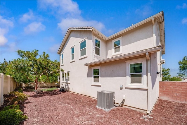 8675 Bay Laurel St, Chino, CA 91708 - rear view of house featuring a fenced backyard, central AC, and stucco siding