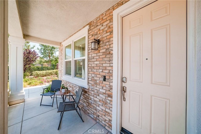 8675 Bay Laurel St, Chino, CA 91708 - doorway to property featuring a porch and brick siding