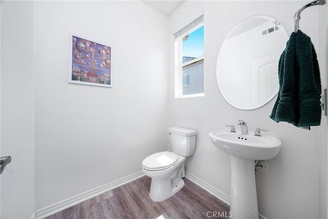 8675 Bay Laurel St, Chino, CA 91708 - half bathroom with wood finished floors, baseboards, toilet, and a sink