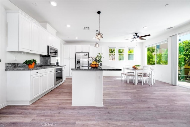 8675 Bay Laurel St, Chino, CA 91708 - kitchen with stainless steel appliances, recessed lighting, white cabinetry, a ceiling fan, and baseboards