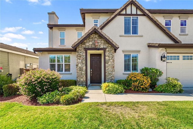 34032 Temecula Creek Rd, Temecula, CA 92592 - view of front facade with stucco siding, stone siding, a garage, and a front yard