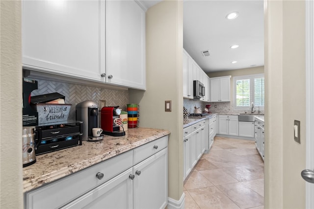 34032 Temecula Creek Rd, Temecula, CA 92592 - kitchen with tasteful backsplash, white cabinetry, appliances with stainless steel finishes, recessed lighting, and light stone counters