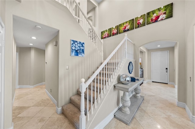 34032 Temecula Creek Rd, Temecula, CA 92592 - staircase with arched walkways, a high ceiling, and recessed lighting