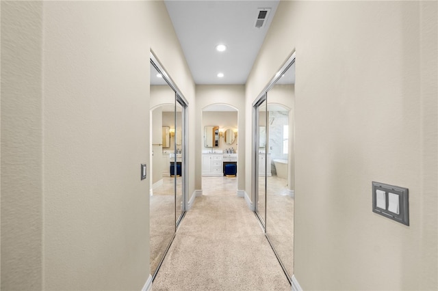 34032 Temecula Creek Rd, Temecula, CA 92592 - corridor featuring arched walkways, light carpet, recessed lighting, and baseboards