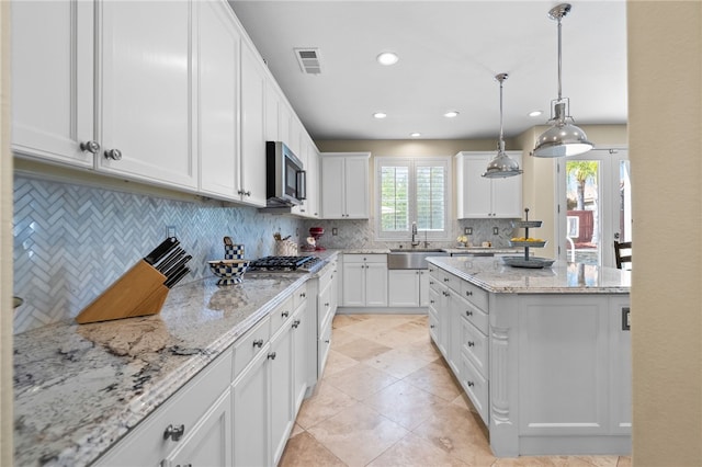34032 Temecula Creek Rd, Temecula, CA 92592 - kitchen featuring a sink, appliances with stainless steel finishes, tasteful backsplash, white cabinets, and light stone counters