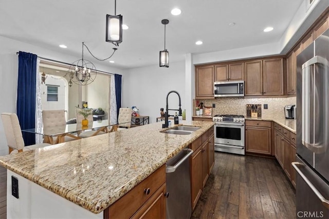 1855 Orizaba Unit 103, Signal Hill, CA 90755 - kitchen featuring appliances with stainless steel finishes, a sink, dark wood-type flooring, brown cabinetry, and recessed lighting